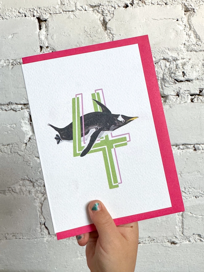 a white card with a big green number 4 and a penguin illustration with a neon pink envelope