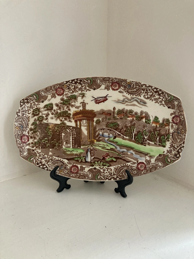 Brown toned vintage plate by W.R Midwinter featuring a classic countryside scene and the addition of a Chinook helicopter in the sky