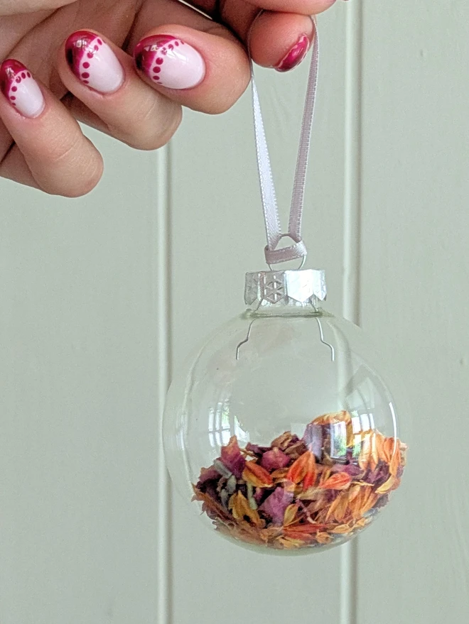pink and orange flower petal in glass bauble