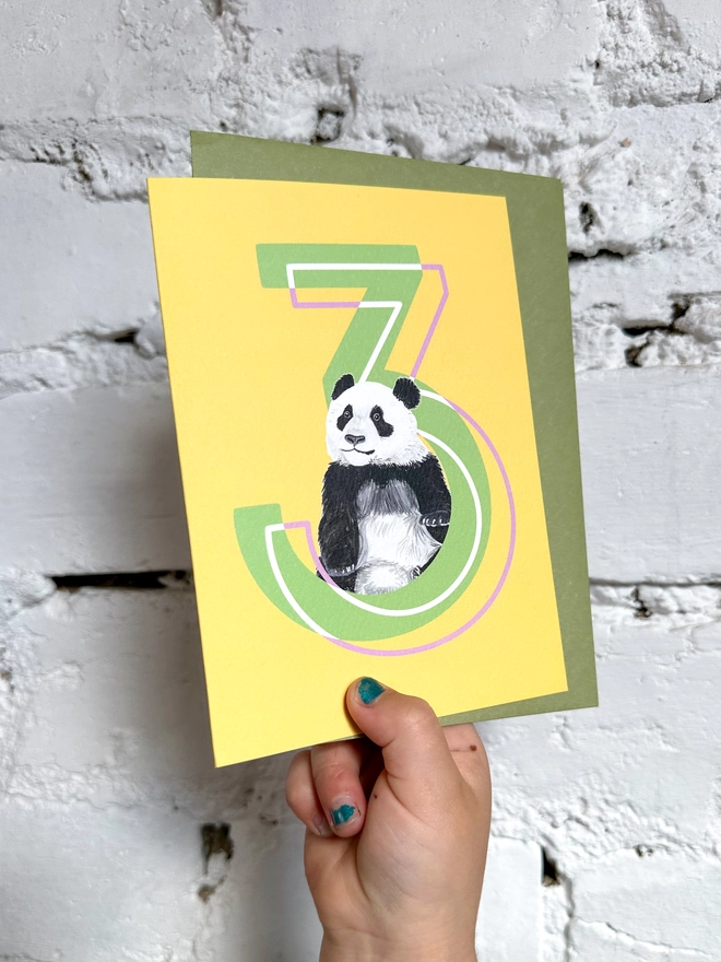 a bright yellow card with a big green number 3 and an illustrated panda with a green envelope