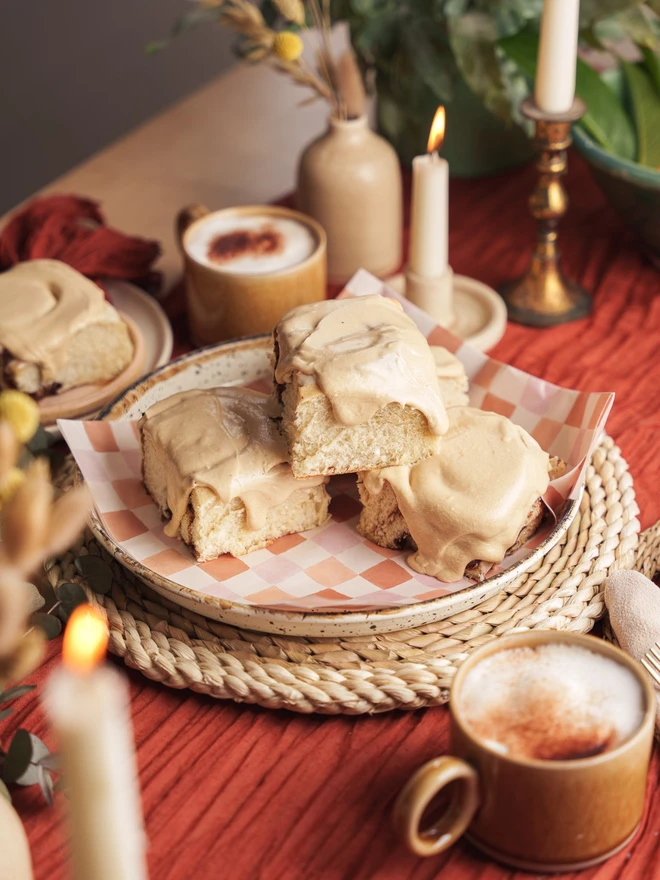 Spiced Latte Buns stacked up on a plate in the center of a table