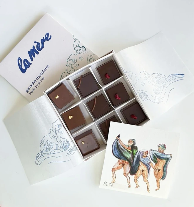 slink ganaches in white box, with watercolour art piece of three women