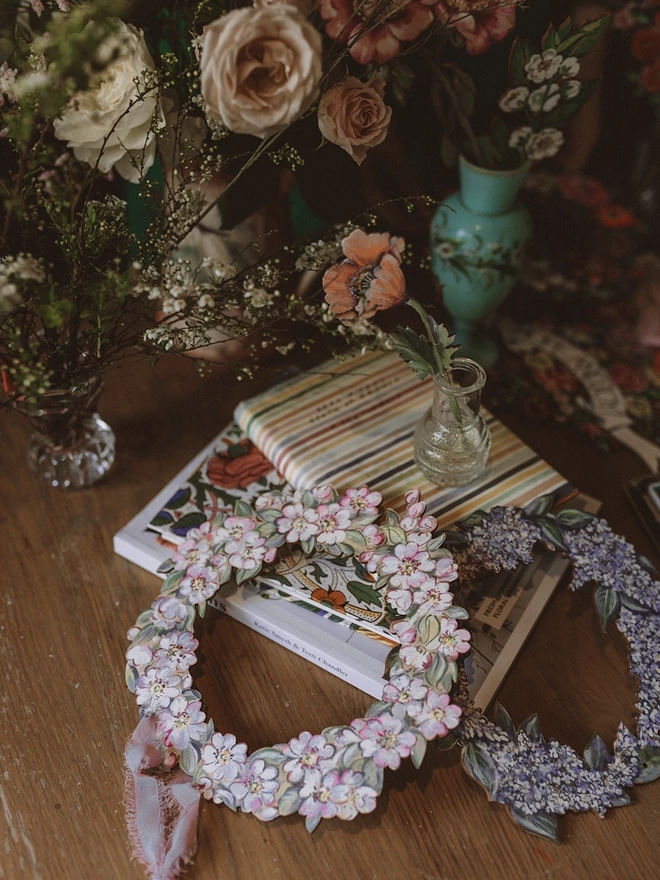 Wooden Blossom & Lilac Garlands, set amongst some books and fresh flowers