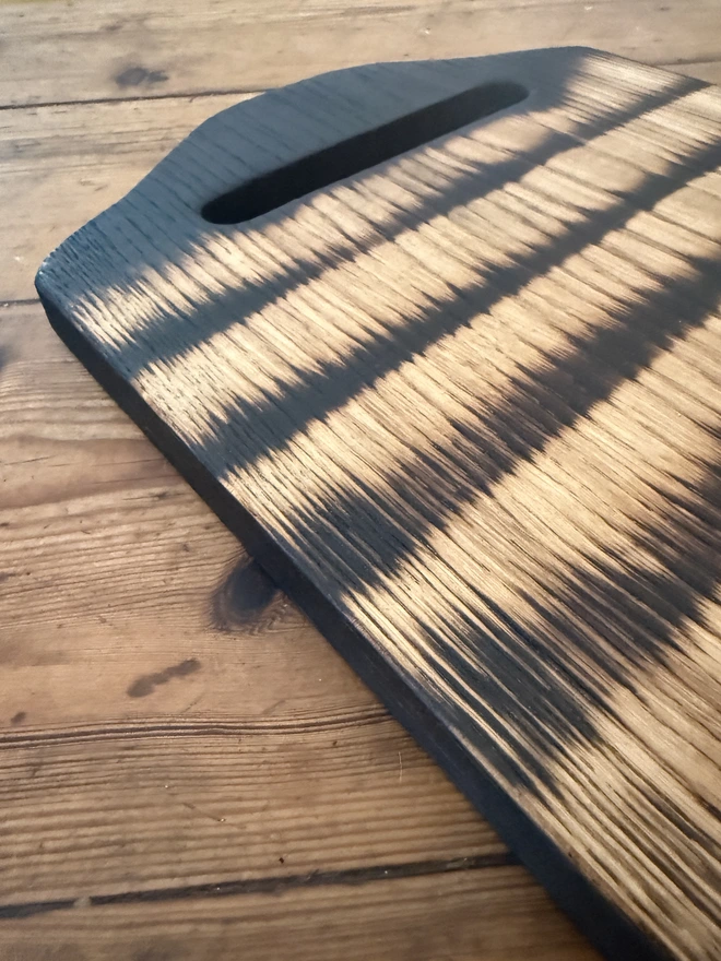 Charred lines on barbecue oak tray serving board
