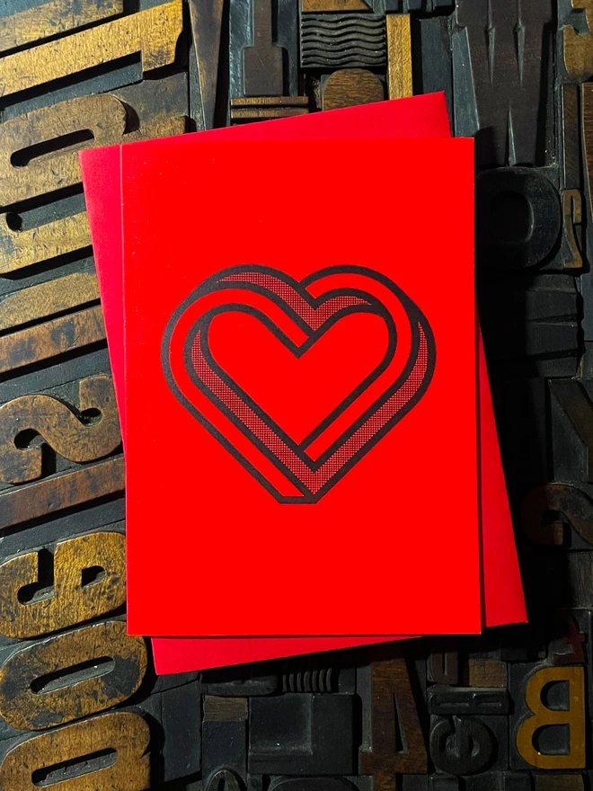 Valentine! A beautiful infinity heart monogram letterpress card printed with rich black ink on thick vibrant Gmund Action Electric Blood colourful card with a luxury matching envelope; ideal to send a to a friend or loved one.