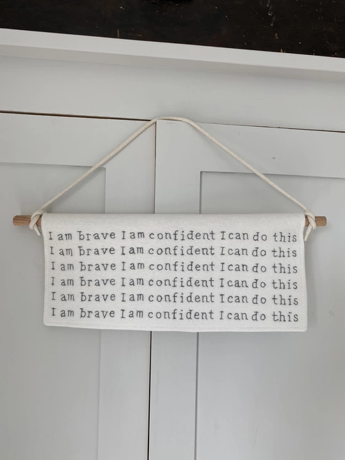 I Am Brave Felt Banner hanging on cupboard