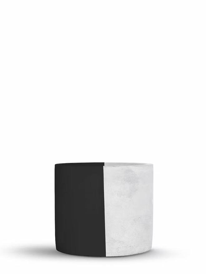 half & half concrete plant pot. a grey concrete plant pot painted half black.