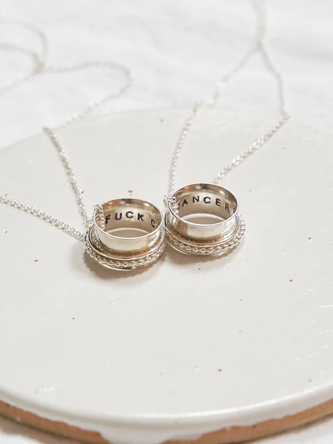 The 'Fuck Cancer' Spinner Pendant Necklace, An adult fidget spinner to give you something tactile to do with your hands. This piece of jewellery is hand made from recycled sterling silver.