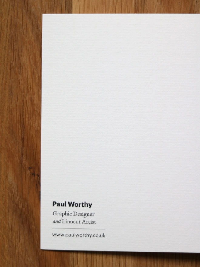 A greetings card feature a teal rose design based on an original linocut print