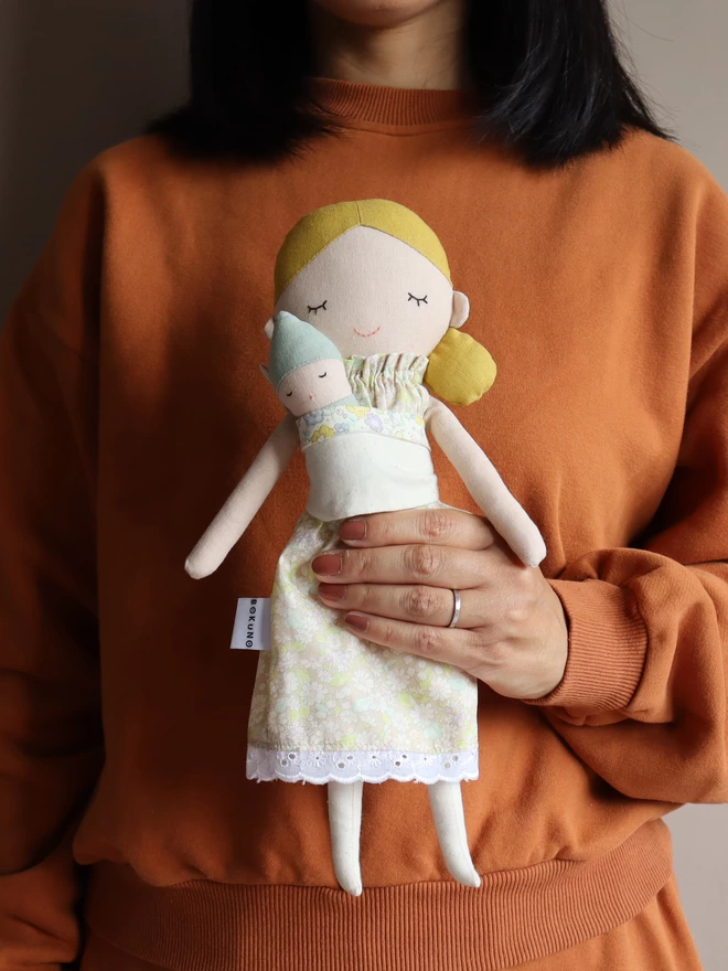 fabric doll with blonde hair and sleeping baby doll in papoche