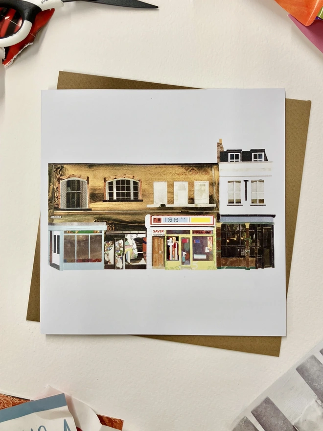  Greetings Card with a collaged illustration of Shoreditch high street with an envelope on a white background with collage materials.