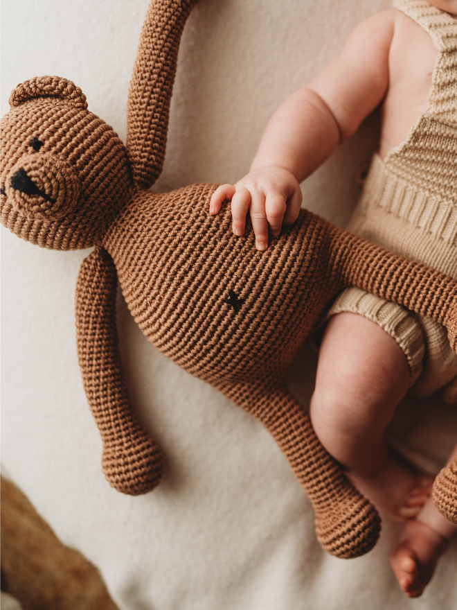 handmade brown crochet teddy bear lifestyle shot