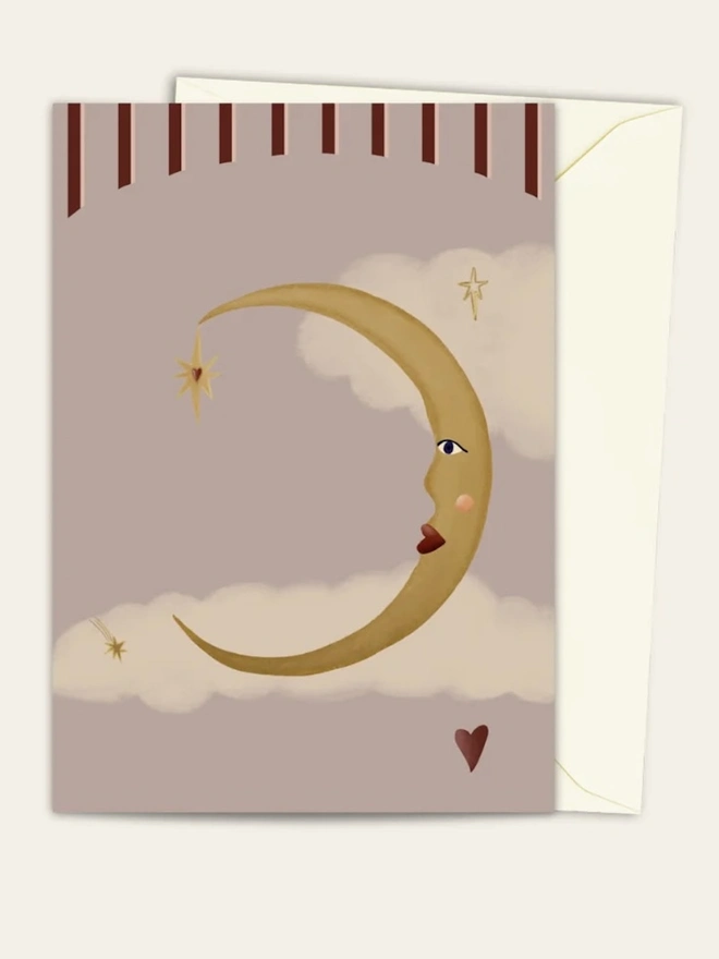 La Lune D'Amour Card, a colourful card sitting on a plain white surface on top of its envelope.