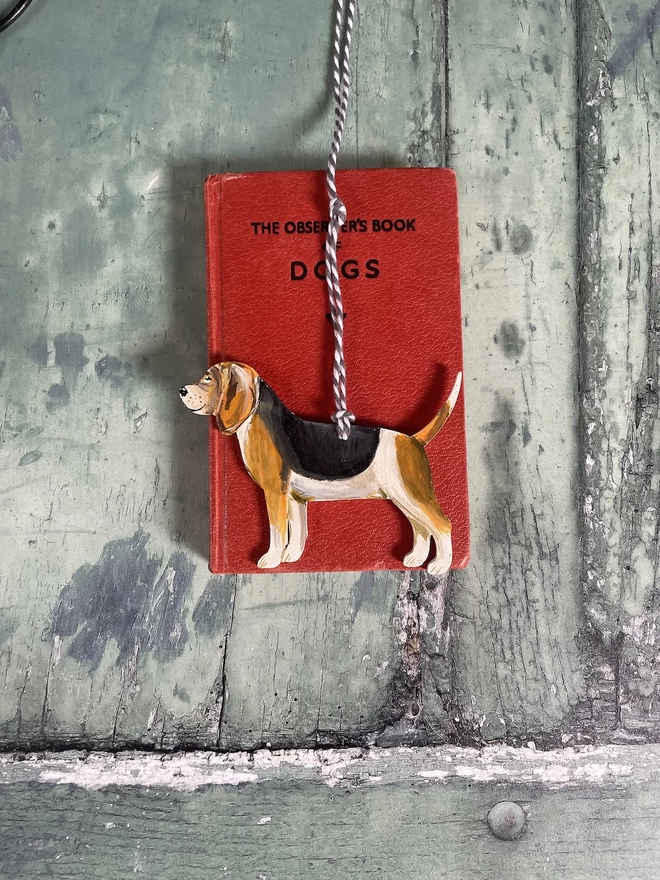 Beagle Dog Memory Decoration placed on a book about dogs