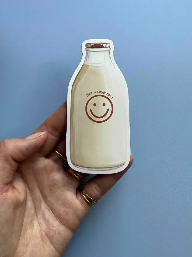 A milk bottle magnet with a smiley face and 'have a nice day' on the bottle