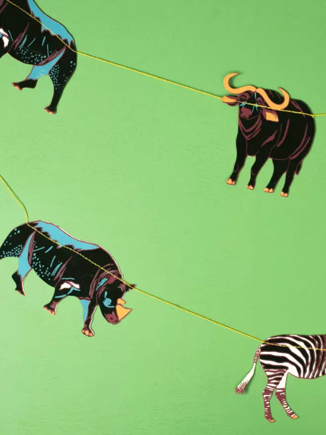 Rhinos, zebras and buffalo against a lime green background