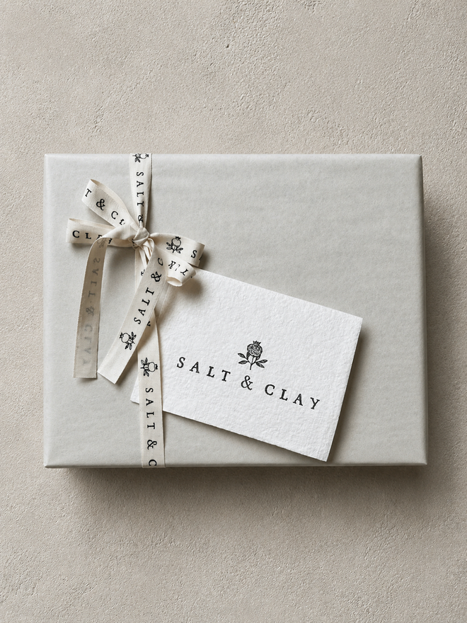 salt and clay gift wrap with ribbon and a note card