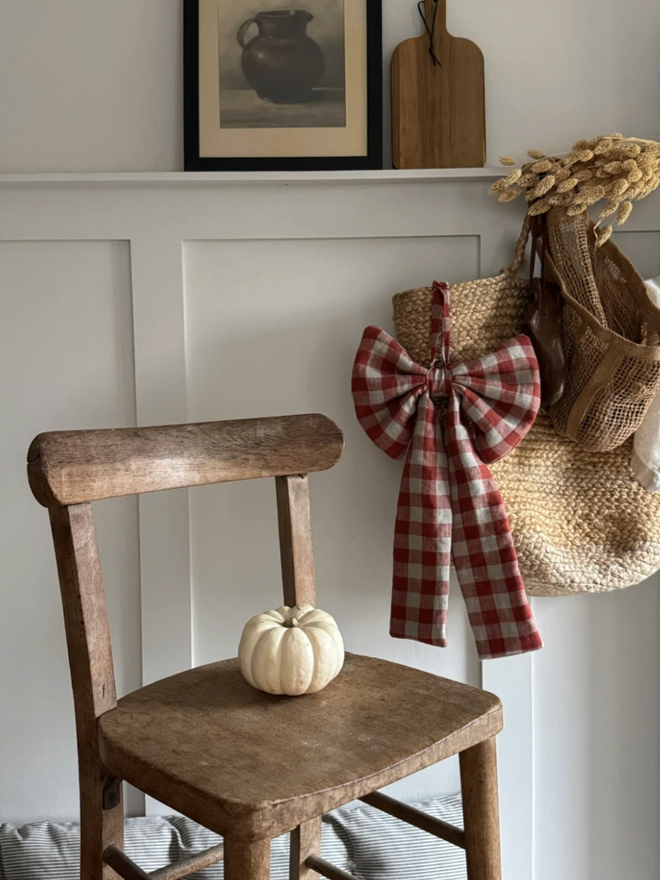 Rusty Gingham Bow. A bow hanging in a home.