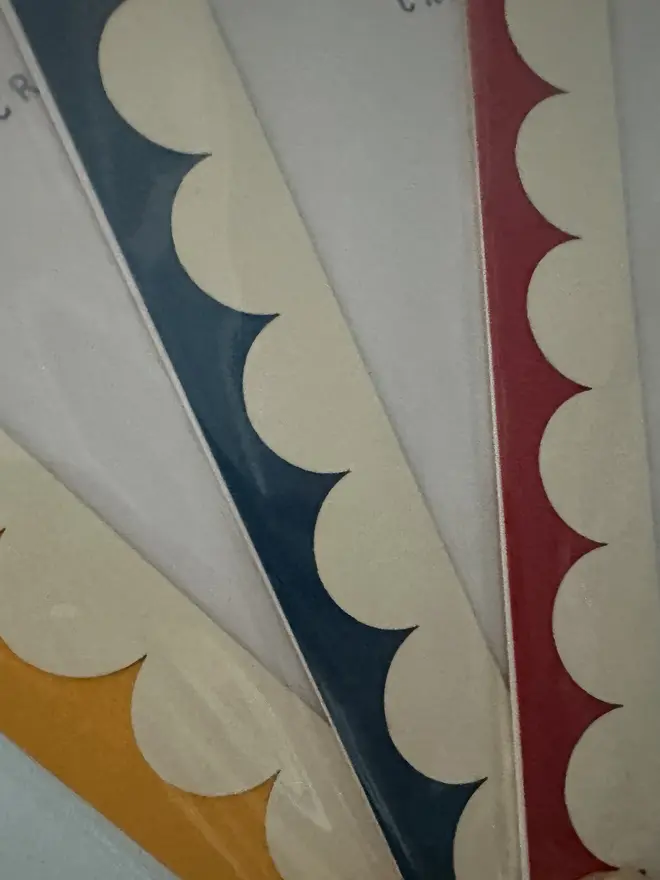 Scallop Edged A5 / A4 photo mount. close up shots of red blue and yellow variants shown against grey background. 