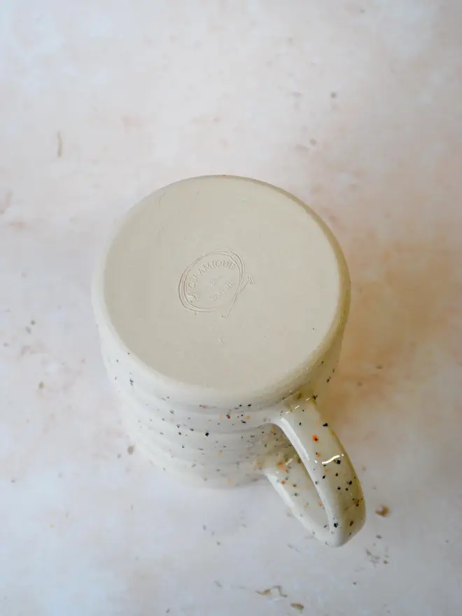 Speckle Pop’ handmade ceramic mug — bottom view showing maker’s mark and ridged base