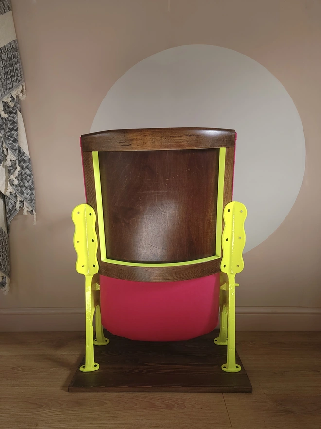 Back of a pink and yellow vintage cineam seat