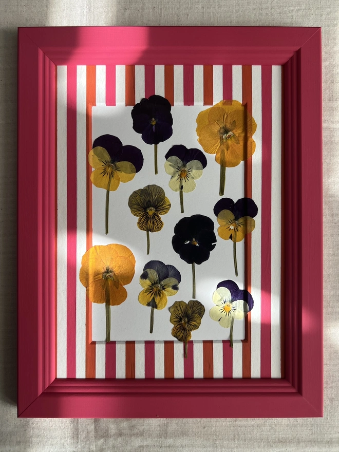 pink painted frame with pressed pansy flowers