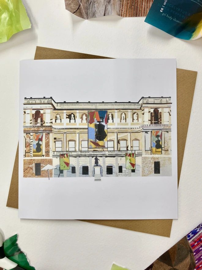 A greetings card showing a paper collage of the Rijksmuseum with a brown envelope on a white background with paper materials