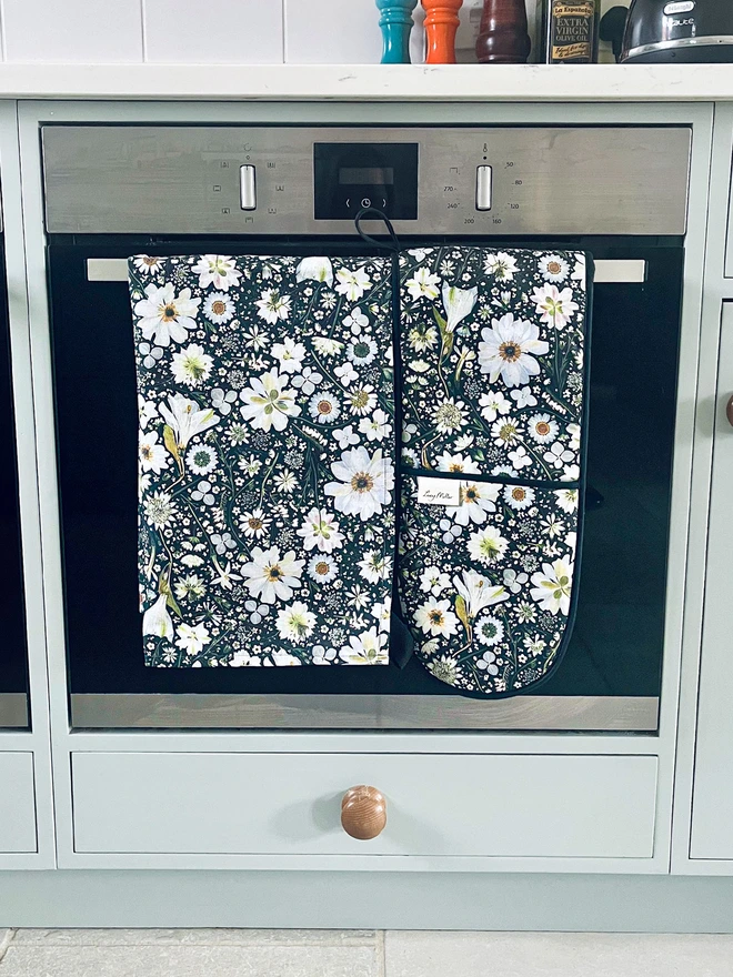 Lucy Miller cotton tea towel and oven gloves with a pressed flower design in black and white.