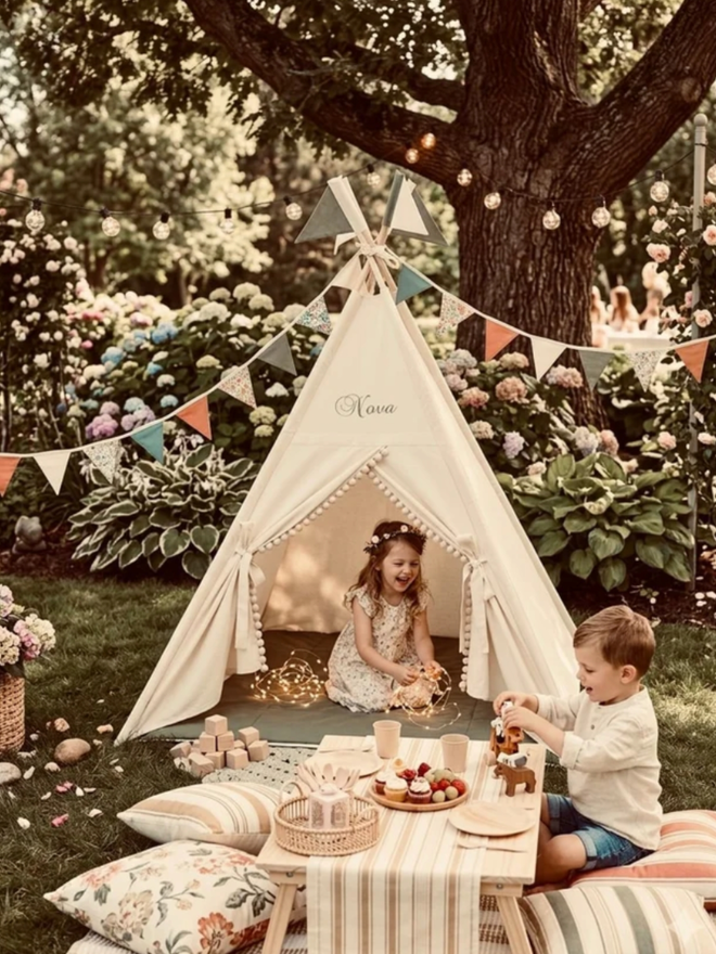Personalised Natural and Olive Teepee. A tent outside for a children’s party.