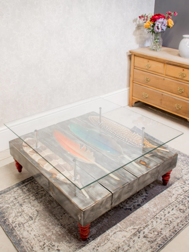 row of feather on grey wash coffee table