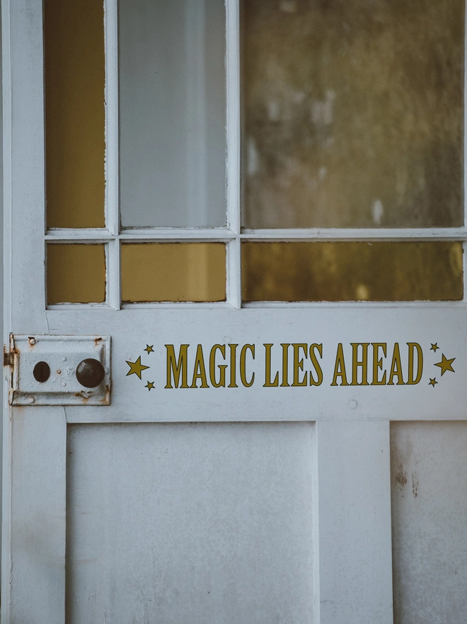 Magic Lies Ahead wall and mirror sticker by Joanie and Jeanie – black lettering decal ideal for teenage bedroom décor and Halloween.