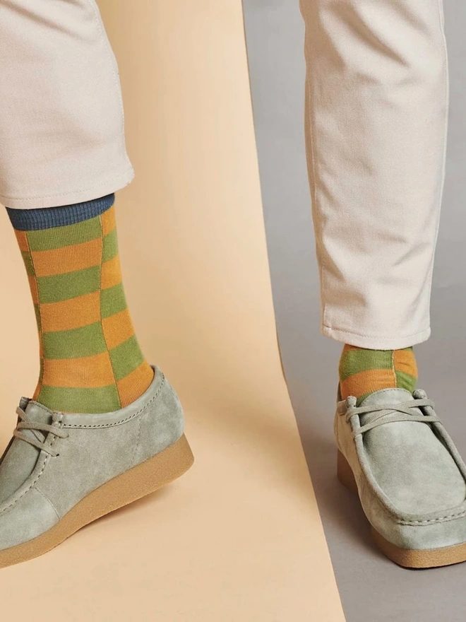 Men's Organic Cotton Ankle Socks Packs (Sets Of 3), a man wearing a pair of colourful patterned socks. 