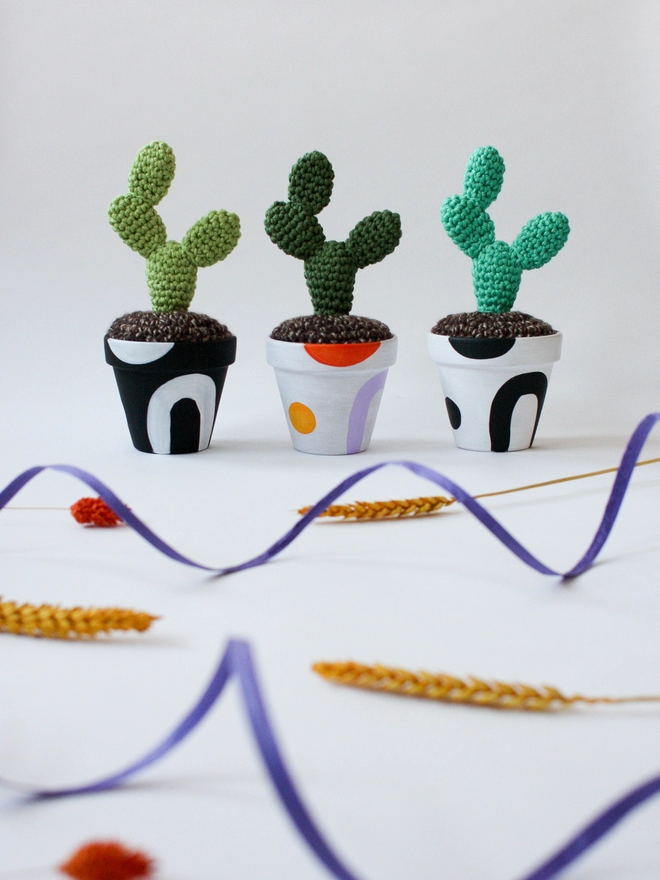 Crocheted cacti in hand-painted shape pots