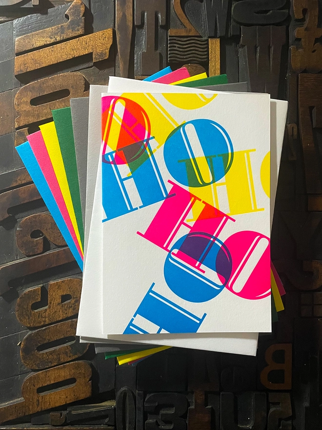 Ho Ho Ho! A beautiful typographic letterpress Christmas card. Printed with rich vibrant and fluorescent blue, magenta and yellow inks with luxury matching and contrasting envelopes; ideal to send to your designer friends at the festive season.