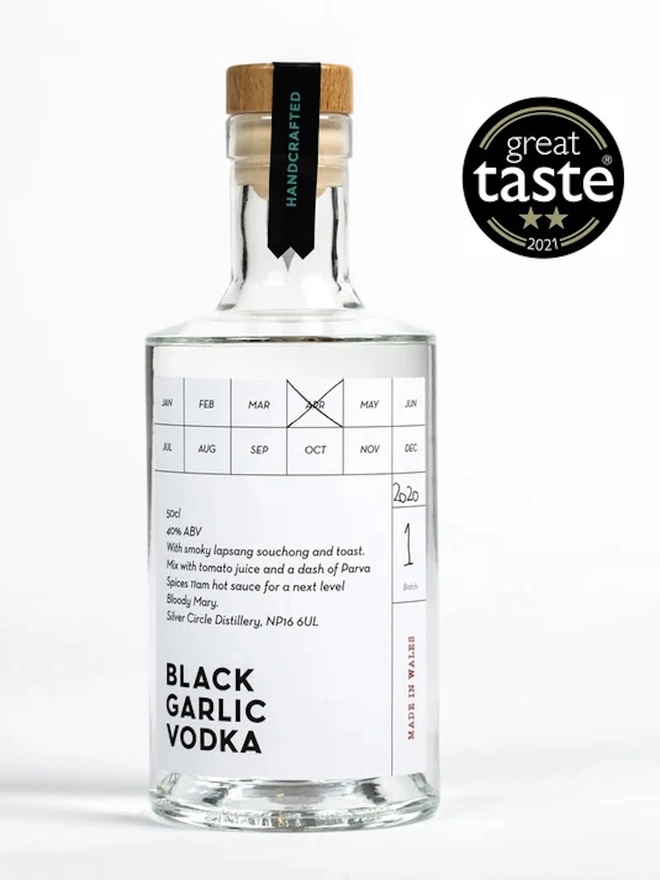 Black Garlic Vodka, bottle of spirit on a white surface. 