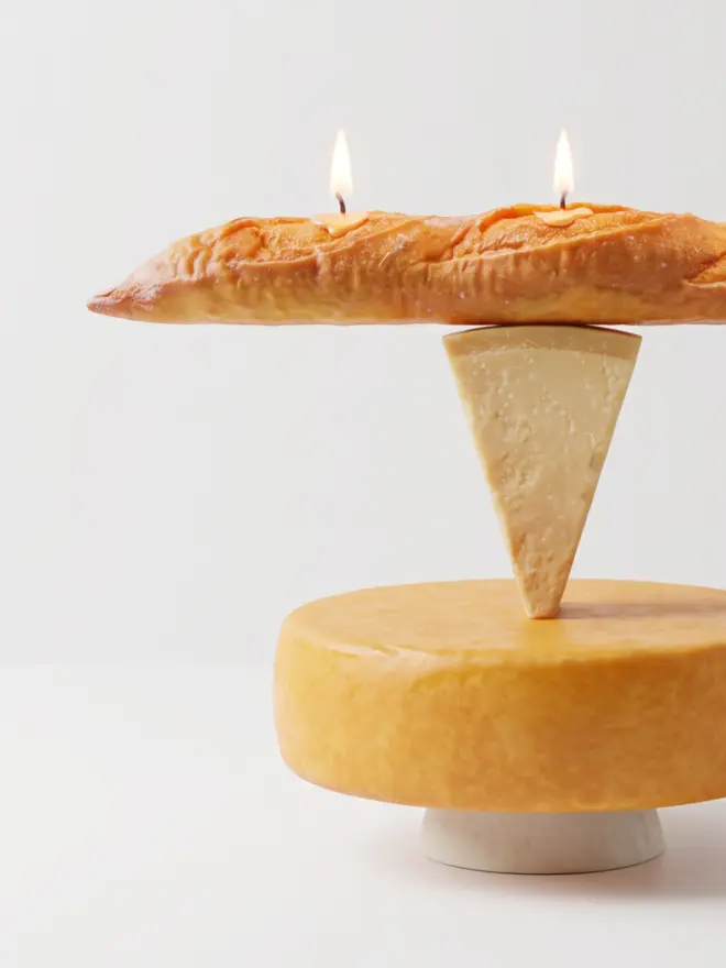 baguette candle on stack of cheese 