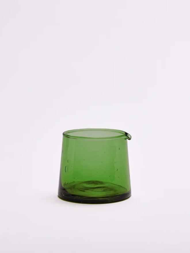 Glass Jugs (Set Of 2), a small green glass jar sitting against a white surface. 