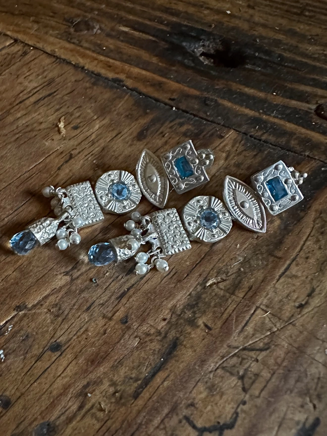 silver totem talisman earrings with topaz 