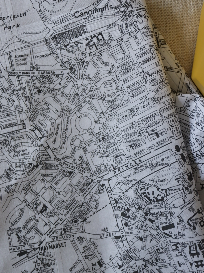 A lifestyle photo of a Mr.PS Edinburgh Map hankie printed in grey with a plant pot