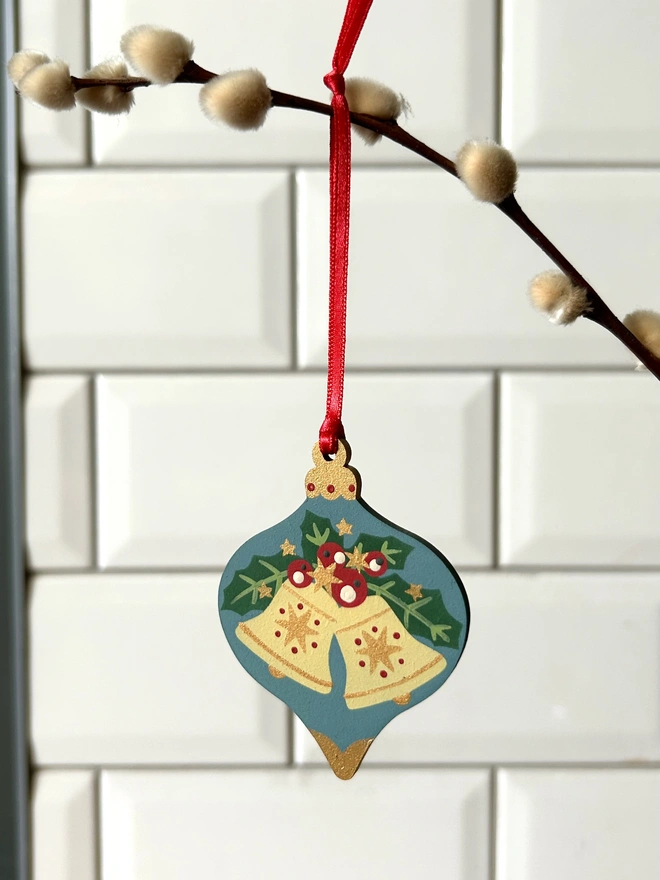 Laser cut wooden bauble shapes which have been hand painted with one christmas candle design and one with a festive bell design. Using blue, yellow, green, red and gold paint.