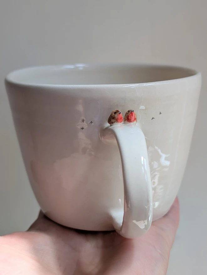 robin couple mug with a tiny pair of robin red breast birds on the cup handle and small bird prints on the white cup