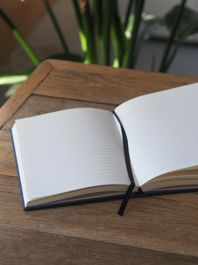 a hardcover journal open desk to show its lay flat properties