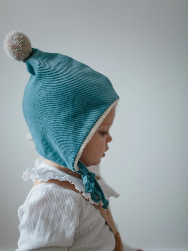 Baby wearing her blue Pixie hat 