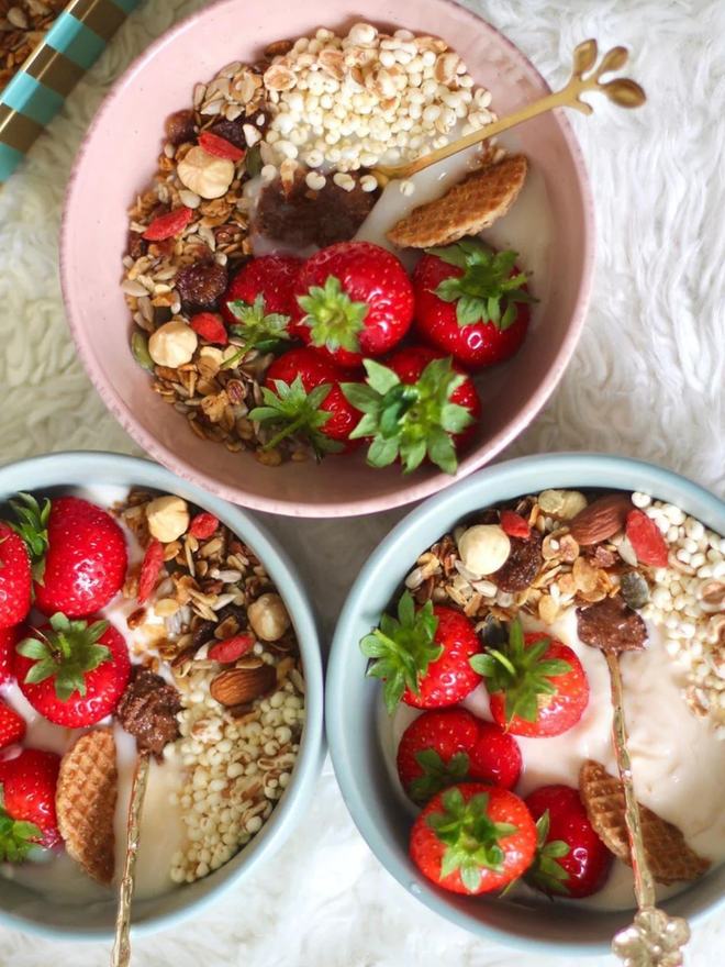 cacao and hazelnut butter. three bowls of porridge topped with fruit and cacao and hazelnut spread.
