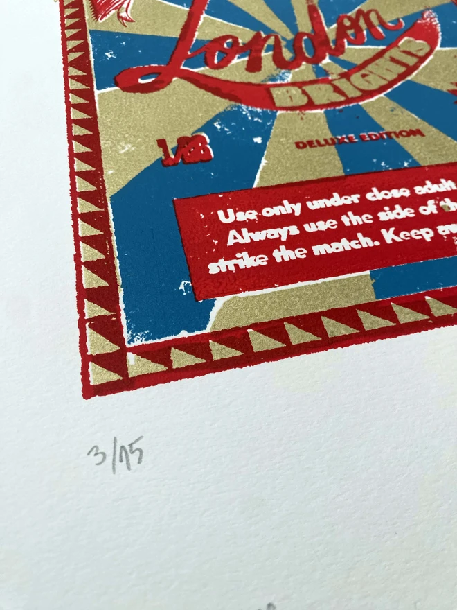 Bring a touch of nostalgic British charm to your space with this striking London Brights limited edition screen-print, inspired by the bold graphics of fireworks labels.     Featuring a vibrant palette of red, blue, and gold, the design showcases dramatic sunburst rays and retro typography, capturing the energy and character of classic mid-century advertising.      Each print includes the artist’s signature and edition number, this piece is perfect for lovers of London, vintage design, and unique statement art.