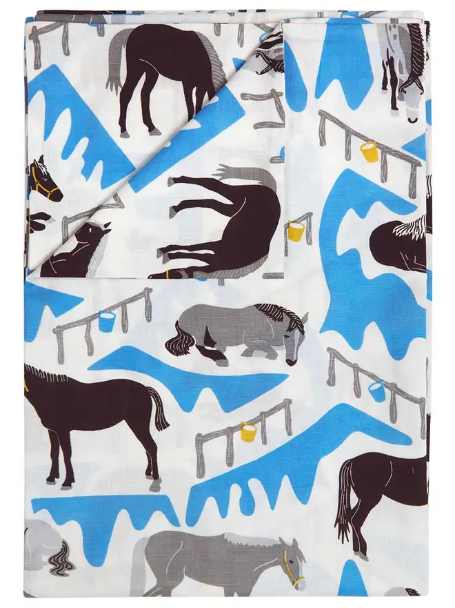 Horse Ranch Duvet Cover And Pillowcase, a blue horse themed set of a duvet cover and pillowcase in a bedroom. 