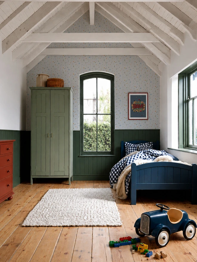 Ducks In A Row Stars and Stripes Twilight in Boys Retro Bedroom with blue bed, red chest of drawers and retro toy car