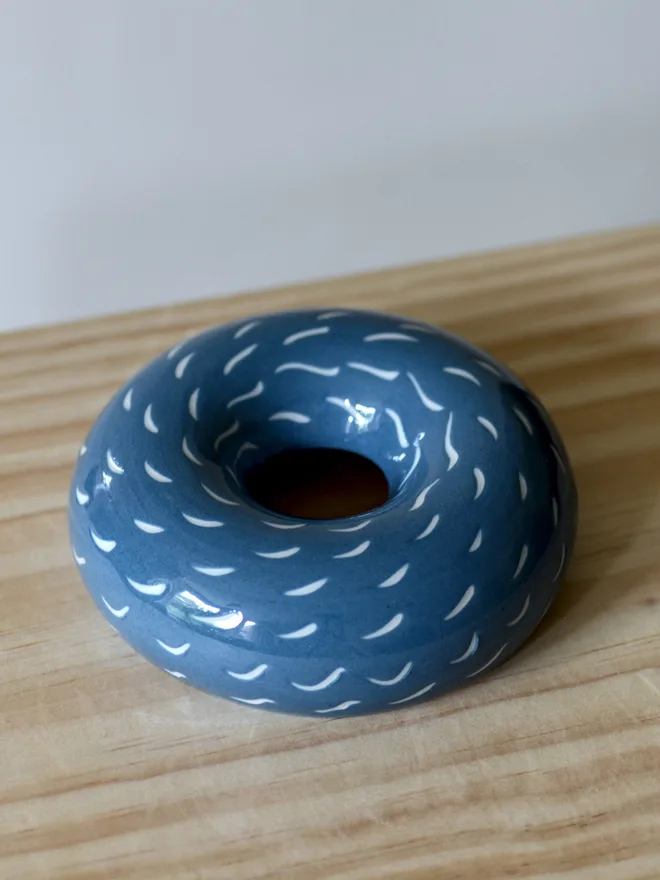 Handmade porcelain avocado planter with carved blue pattern, designed to hold an avocado seed for sprouting