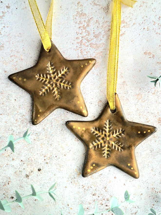 Star Christmas decorations, ceramic decorations, dream catcher, christmas star, pottery, Jenny Hopps Pottery, J.H Pottery, J.Hopps Pottery, Clay star, gift, christmas tree, blue with white and cream with gold details, on a light gold ribbon, photographed on a branch with Christmas lights, ceramic gifts for her, gifts for mum, gifts for sister, gifts for friend, gifts for girlfriend, gift for dad, ceramic gift for dad, gift for husband, gift for son, gift for teens, gifts for teenagers, gift for home, homeware gift, 