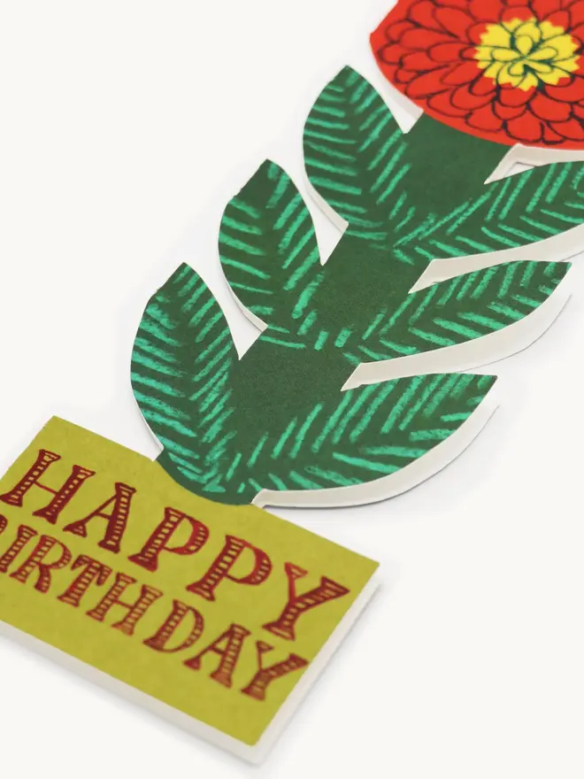 red and green flower shaped card with happy birthday text